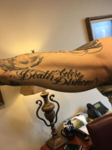 biker lawyer client arm tattoo