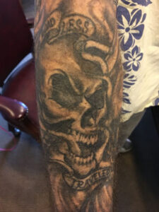 biker lawyer client arm tattoo back view