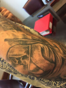 biker lawyer client arm tattoo side view